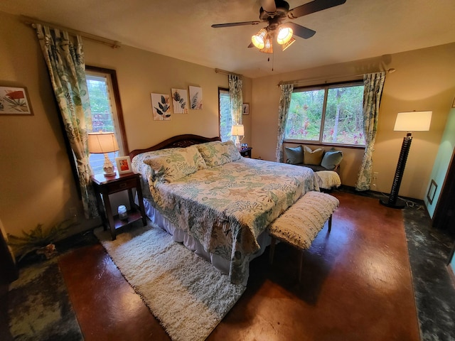 bedroom with ceiling fan and multiple windows