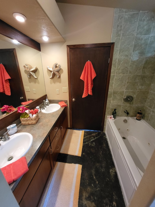 bathroom with a tub to relax in and vanity