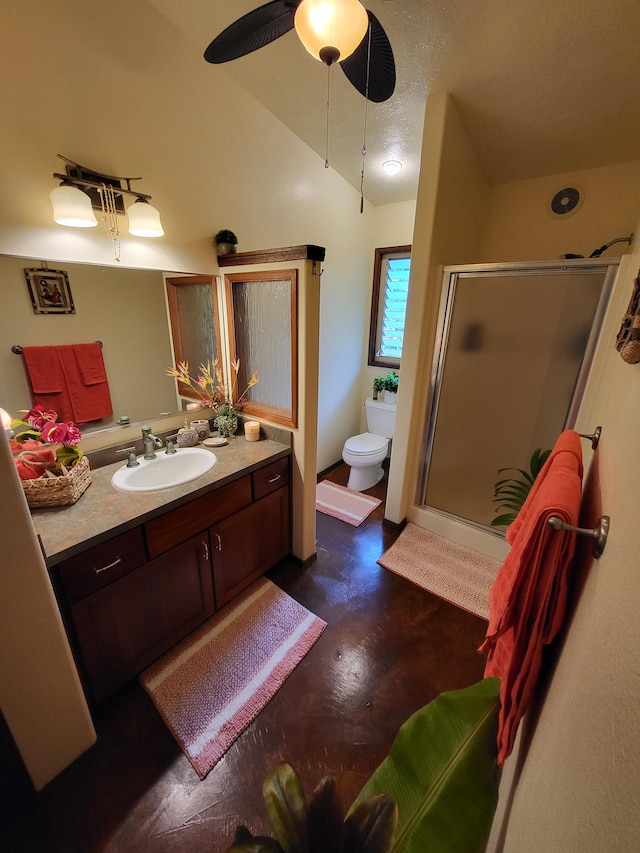 bathroom with toilet, a shower with shower door, ceiling fan, vaulted ceiling, and vanity