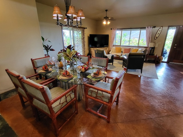 tiled dining area with ceiling fan with notable chandelier and a healthy amount of sunlight