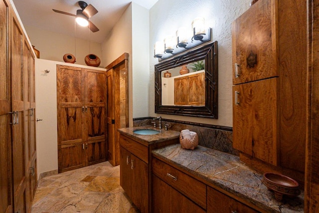 bathroom with ceiling fan and vanity