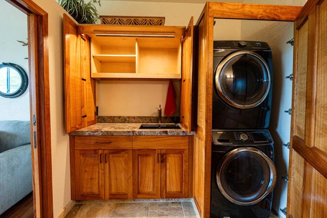 laundry area featuring sink and stacked washer / drying machine