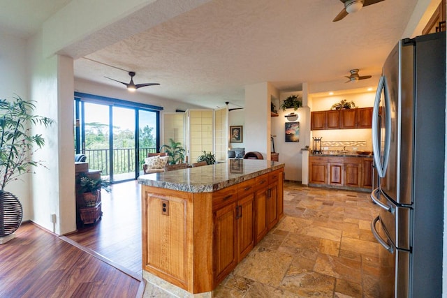 kitchen featuring a center island and stainless steel refrigerator