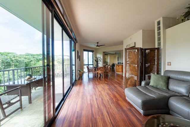 living room featuring hardwood / wood-style floors and ceiling fan