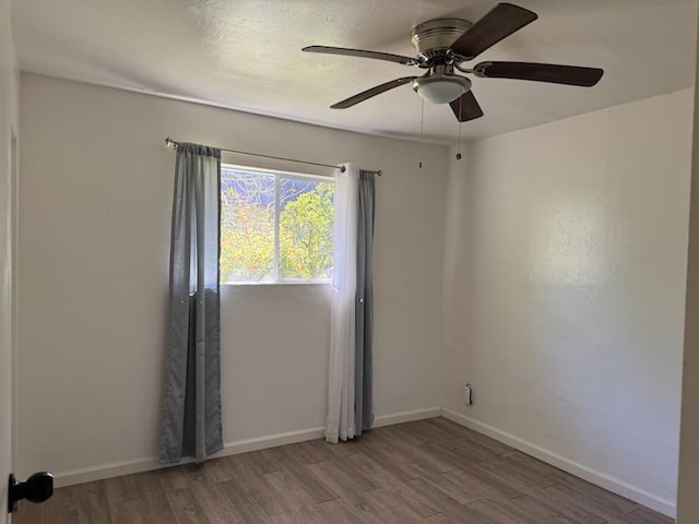 spare room with light hardwood / wood-style flooring and ceiling fan