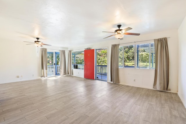 unfurnished room featuring ceiling fan and a wealth of natural light