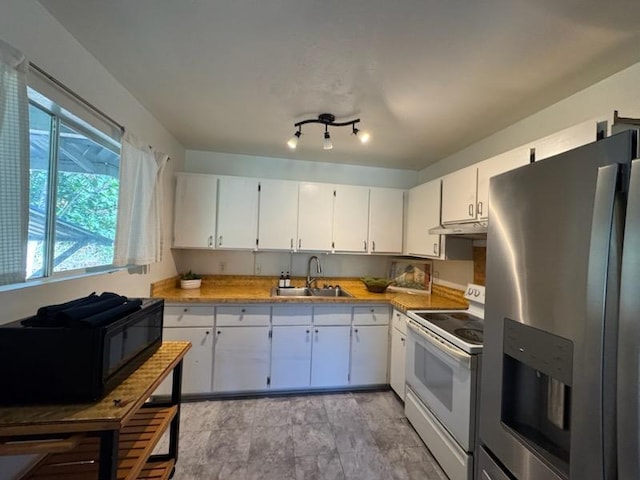 kitchen with white electric range oven, sink, white cabinetry, and stainless steel refrigerator with ice dispenser