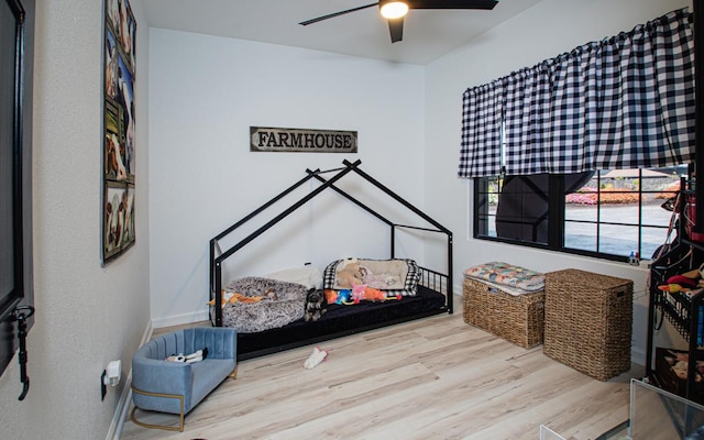 bedroom with ceiling fan and light hardwood / wood-style floors