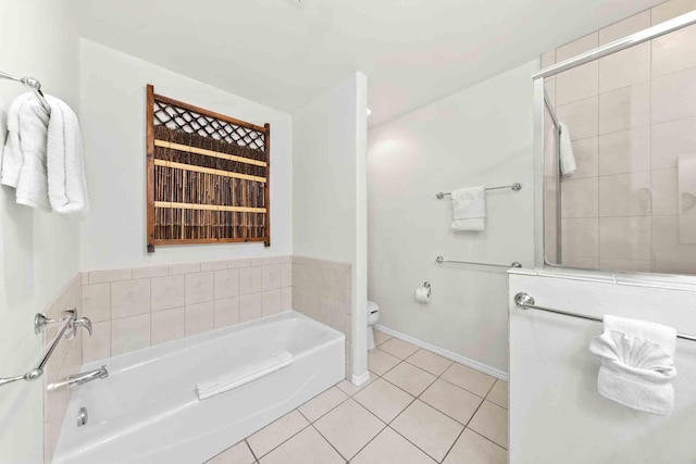 bathroom with tile patterned flooring, toilet, and a washtub