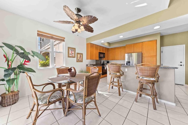 dining space featuring light tile patterned floors and ceiling fan