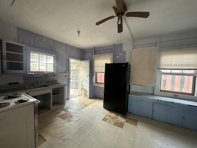 kitchen featuring ceiling fan, sink, black fridge, and white electric range