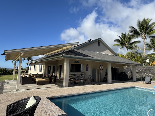 back of property featuring a fenced in pool, a patio area, and an outdoor living space