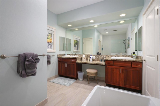 bathroom with shower with separate bathtub, vanity, and hardwood / wood-style floors