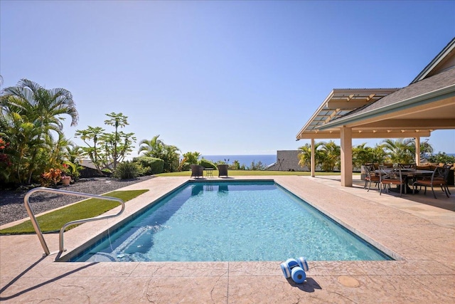 view of swimming pool featuring a patio area and a water view