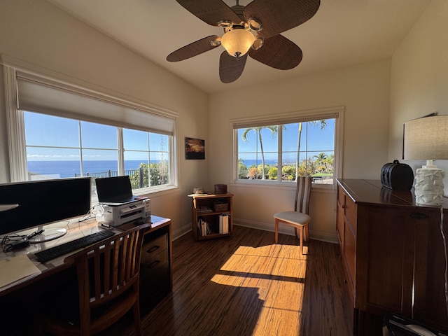 home office with dark hardwood / wood-style flooring, plenty of natural light, and ceiling fan