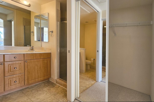 bathroom featuring vanity, toilet, and an enclosed shower