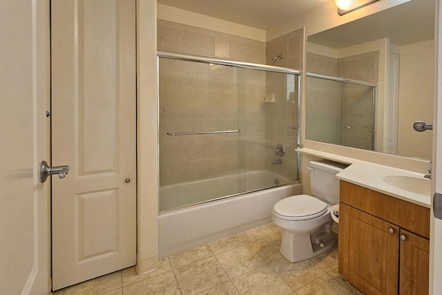 full bathroom with tile patterned floors, toilet, combined bath / shower with glass door, and vanity