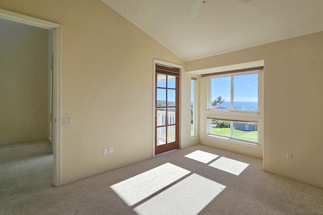 carpeted empty room featuring lofted ceiling