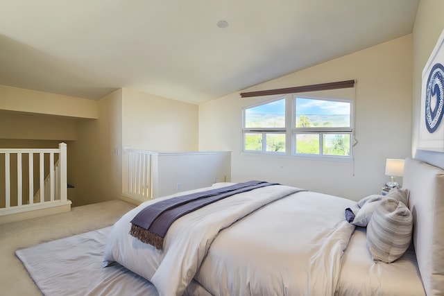 bedroom with lofted ceiling and light carpet