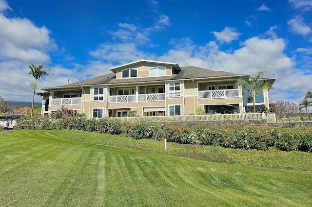 rear view of property with a lawn