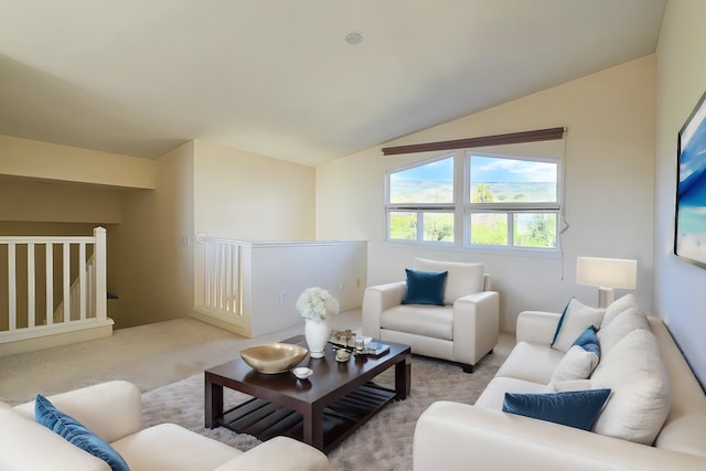 carpeted living room with lofted ceiling