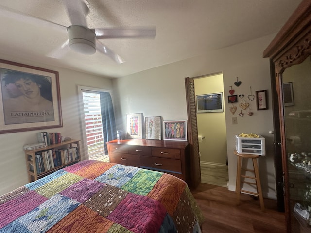 bedroom with dark hardwood / wood-style floors and ceiling fan