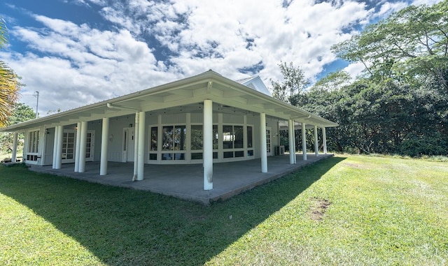 view of property's community featuring a yard and a patio