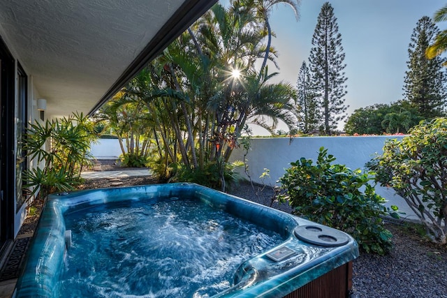 view of swimming pool with a hot tub