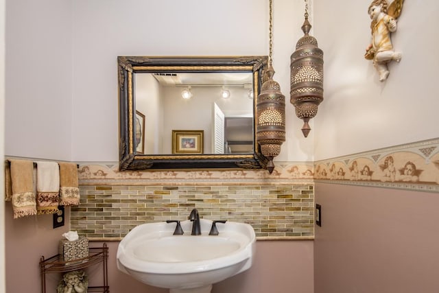 bathroom featuring decorative backsplash and sink