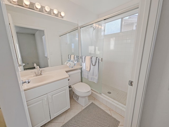 bathroom with vanity, toilet, tile patterned flooring, and walk in shower