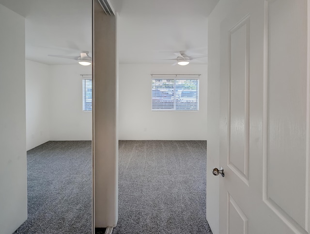 carpeted spare room with ceiling fan