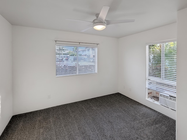 spare room with ceiling fan, cooling unit, and dark carpet