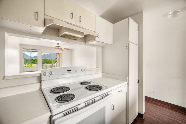 kitchen featuring dark wood-type flooring, ceiling fan, and electric range