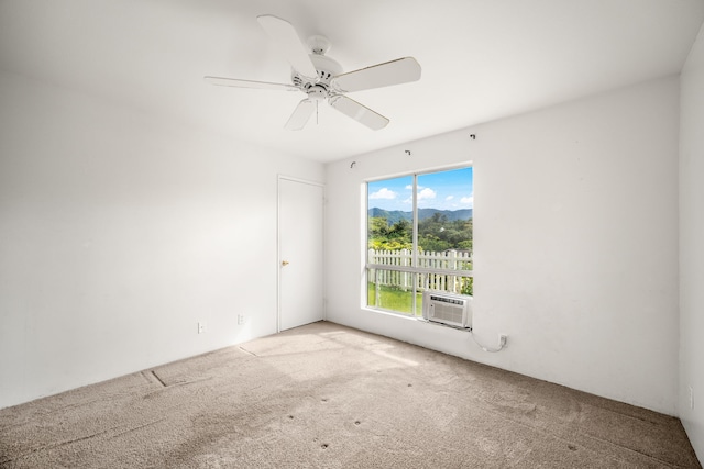 unfurnished room featuring cooling unit, ceiling fan, and carpet flooring