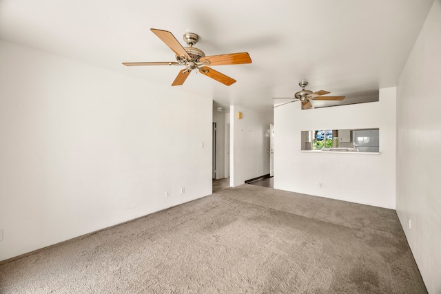 carpeted empty room featuring ceiling fan