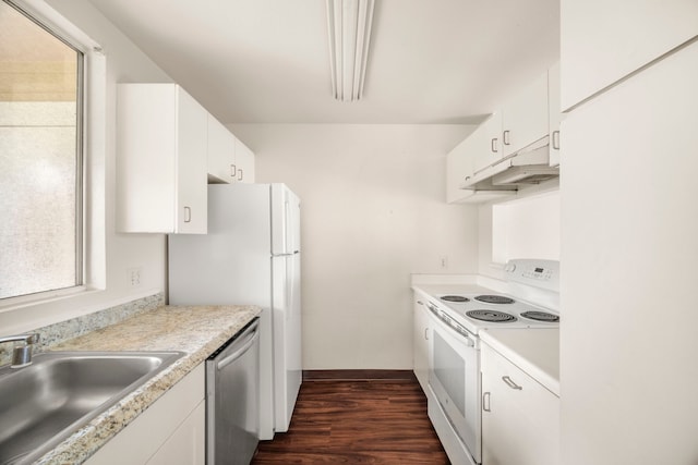 kitchen with dark hardwood / wood-style floors, white cabinetry, sink, and white appliances