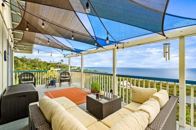 wooden terrace featuring an outdoor living space and a water view