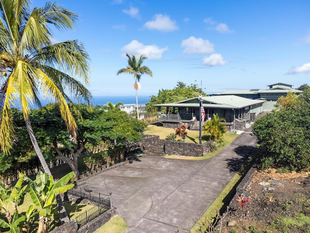 view of patio with covered porch and a water view