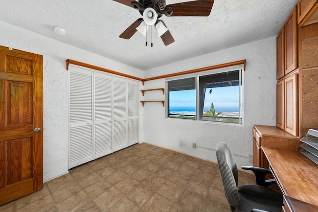 office area featuring ceiling fan and a textured ceiling