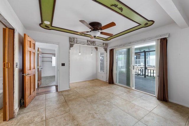 spare room with ceiling fan and light tile patterned floors