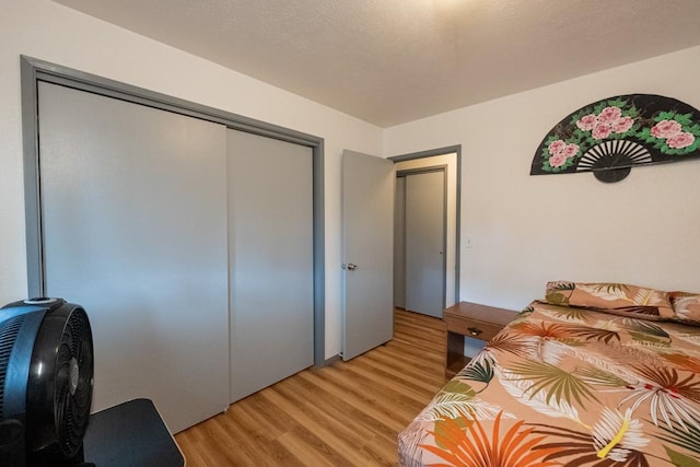 bedroom with a closet and light hardwood / wood-style flooring