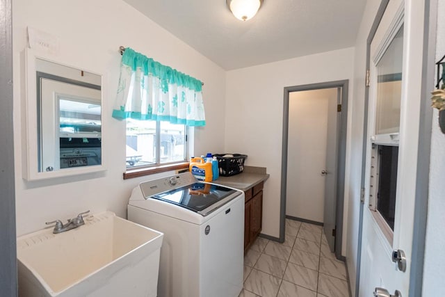 washroom with cabinets, washer / clothes dryer, and sink