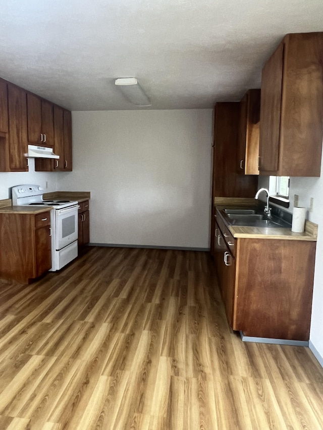 kitchen with dark wood-type flooring, sink, and electric range