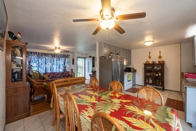 dining room with ceiling fan and light tile patterned floors