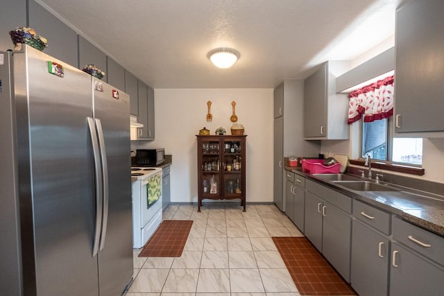 kitchen with sink, stainless steel fridge, gray cabinetry, and white electric range oven