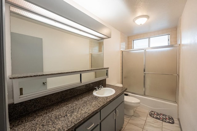 full bathroom with toilet, bath / shower combo with glass door, tile patterned floors, and vanity