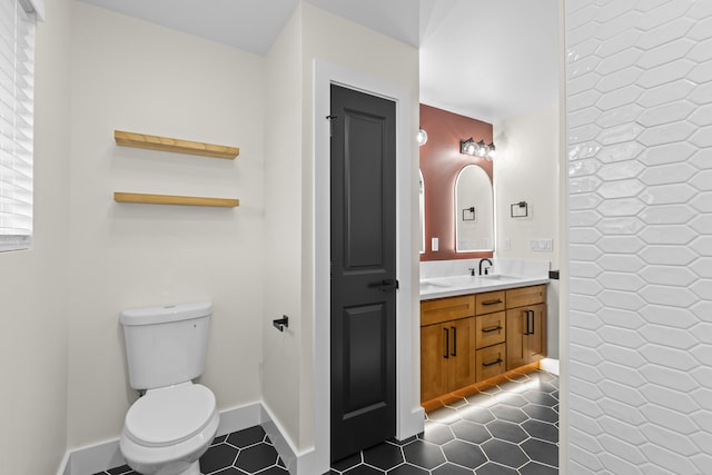 bathroom featuring tile patterned floors, vanity, and toilet