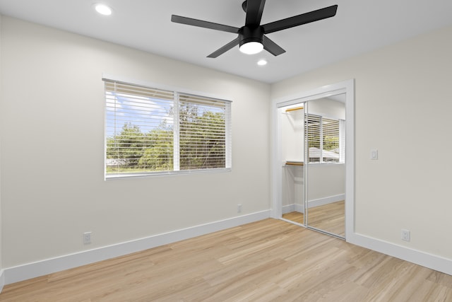 unfurnished bedroom featuring light wood-type flooring, a closet, and ceiling fan