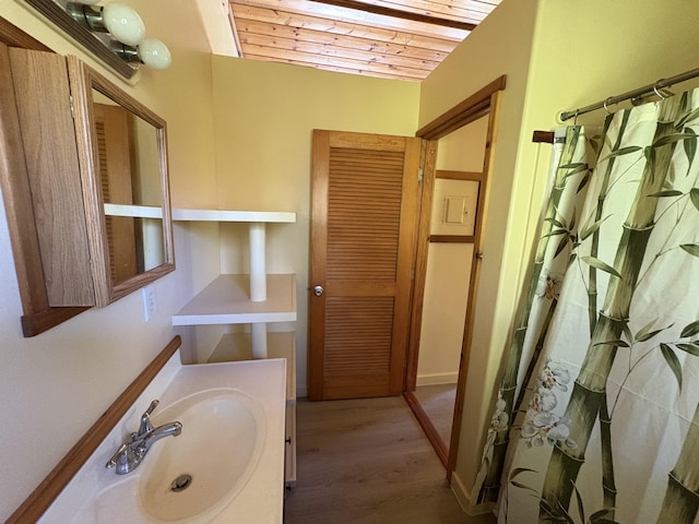 bathroom with sink, wood ceiling, and wood-type flooring