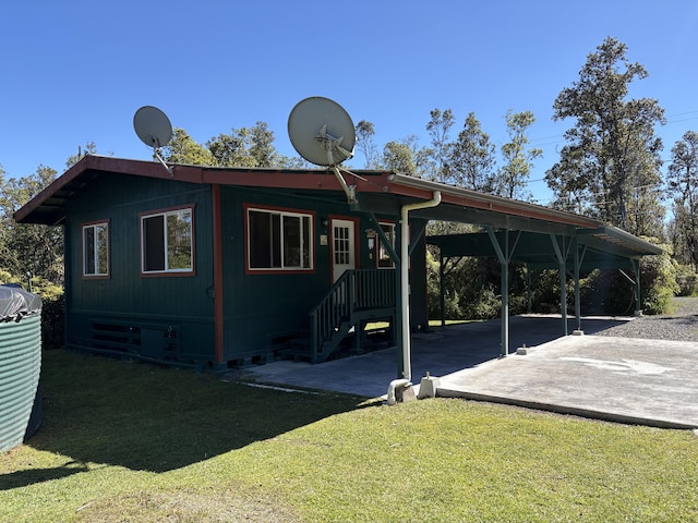 back of property featuring a lawn